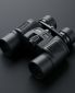nano-banana-2_A_binoculars_placed_diagonally_from_bottom-left_to_top-right_on_a_clean_dark_gra-0