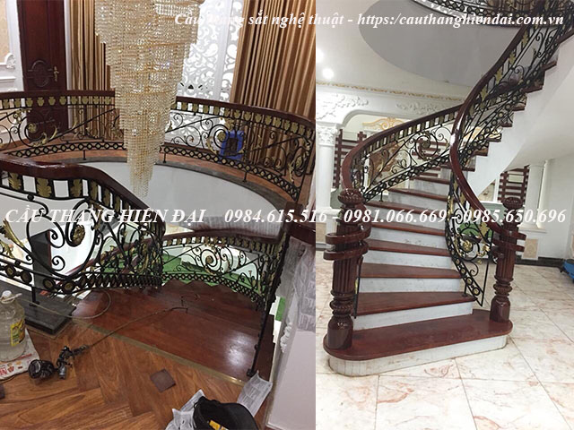 Cầu thang sắt mỹ thuật cổ điển sang trọng, kết cấu bởi các họa tiết sắt trang trí, tay vịn gỗ lim nam phí